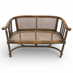 20th century bergère two seater settee, with shaped curved top rail and downswept arms, th...