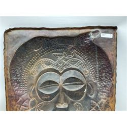 Copper panel embossed with a design of an African mask, H70cm, W50cm