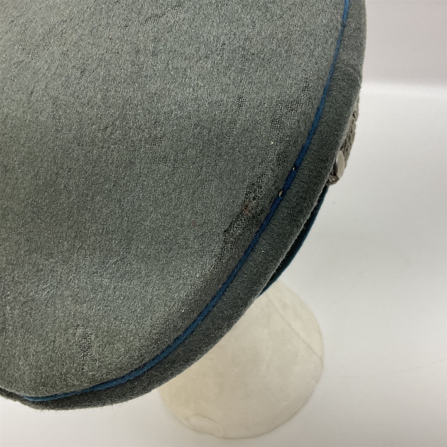 WW2 German Infantry Officer's visor cap with cloth insignia; labelled and stamped Offizier Kleiderkasse Berlin and Erel Stirnschutz
