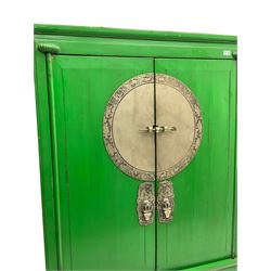 Chinese green lacquered hardwood moon cabinet, two panelled doors with metal mounts decorated with the zodiac animals and traditionally dressed figures, enclosing two drawers and shelves over single secret compartment