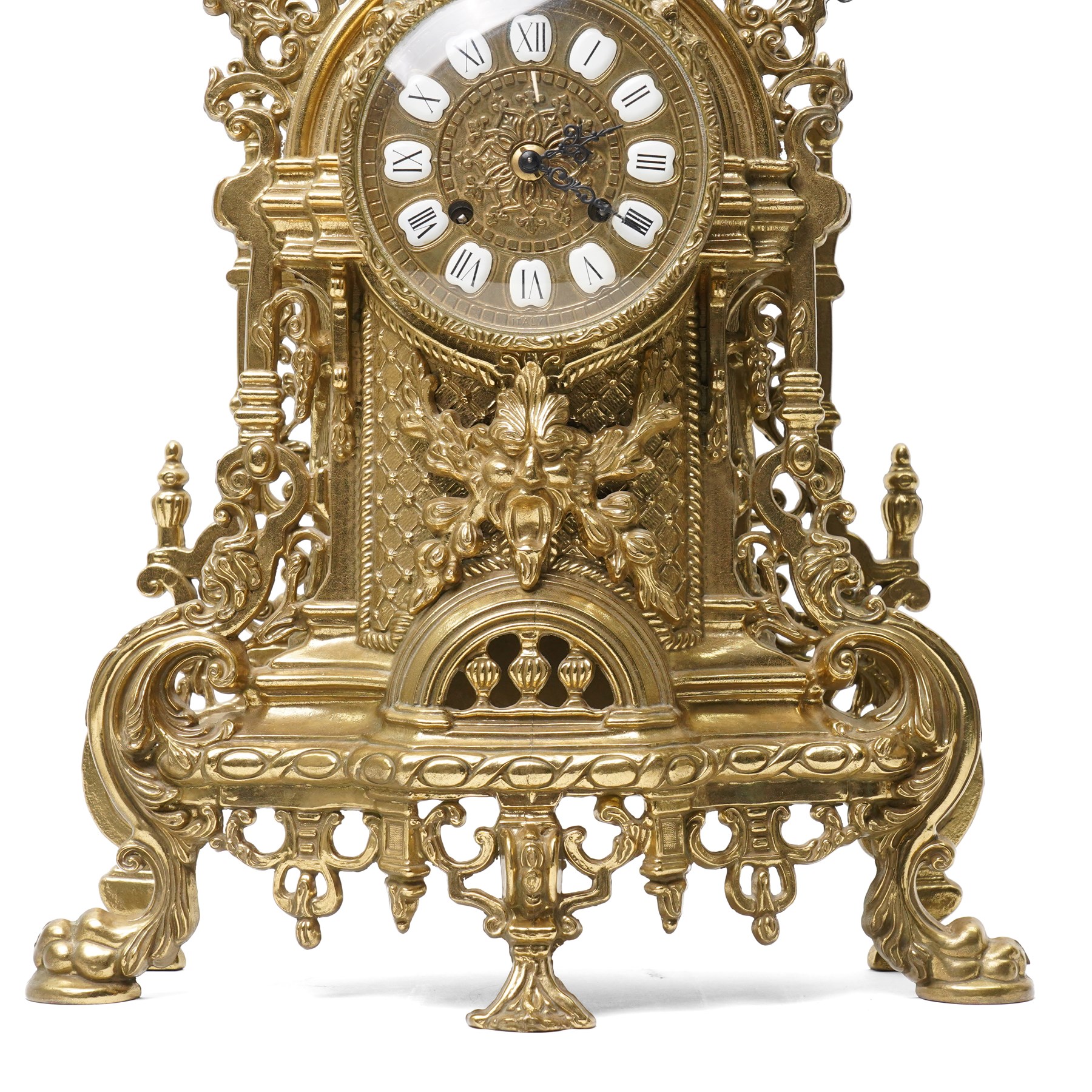 19th century design mantel clock, the brass dial with porcelain numerals, bell strike in brass case of rococo design with urn finial H60cm
