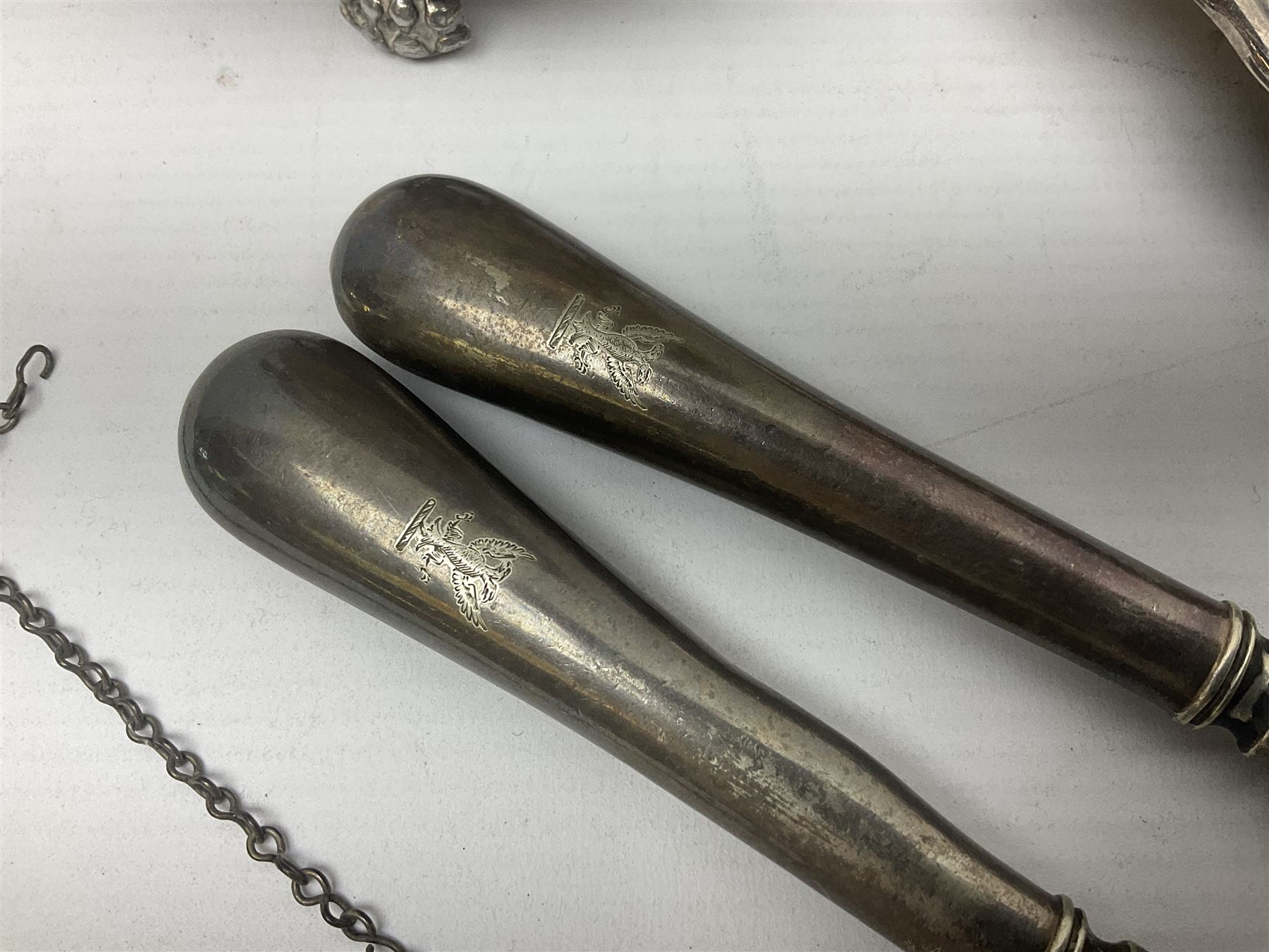 Silver plated tray, with shaped rim and embossed with a dog and crown to centre, stamped Valenti, together with three silver plated decanter labels, two port and one Bucellas, a plated cream jug with embossed floral decoration and a pair of plated fish knives engraved with double headed eagle to handle, tray W25.5