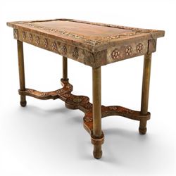 Arts and Crafts copper mounted coffee table, rectangular top with embossed foliate border and stylised corner motifs, studwork detail, on cylindrical supports united by pierced shaped stretcher with applied flowerhead bosses
