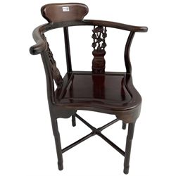 Chinese carved hardwood corner chair, outswept arms over pierced and carved floral splats, raised on shaped cylindrical supports united by X-stretcher
