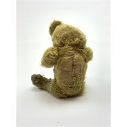 Early 20th century English teddy bear, WW1 period, with wood wool filled mohair body, fixed head with one boot button eye and vertically stitched nose and mouth and jointed limbs with cloth paw pads H16