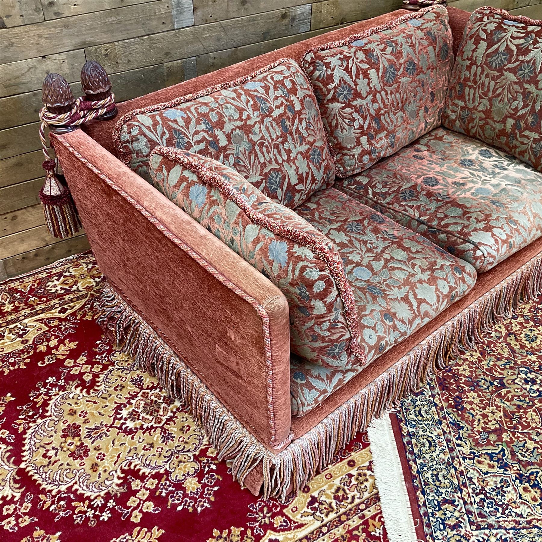 Knole type drop arm sofa with cushions in a traditional patterned upholstery,