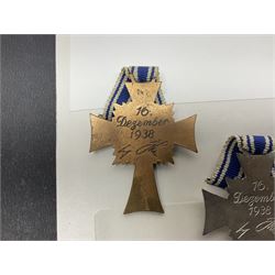 WWII set of three German Mother's Crosses, 1st Class in gilt, 2nd Class in silver and 3rd Class in bronze; all with ribbons (3)