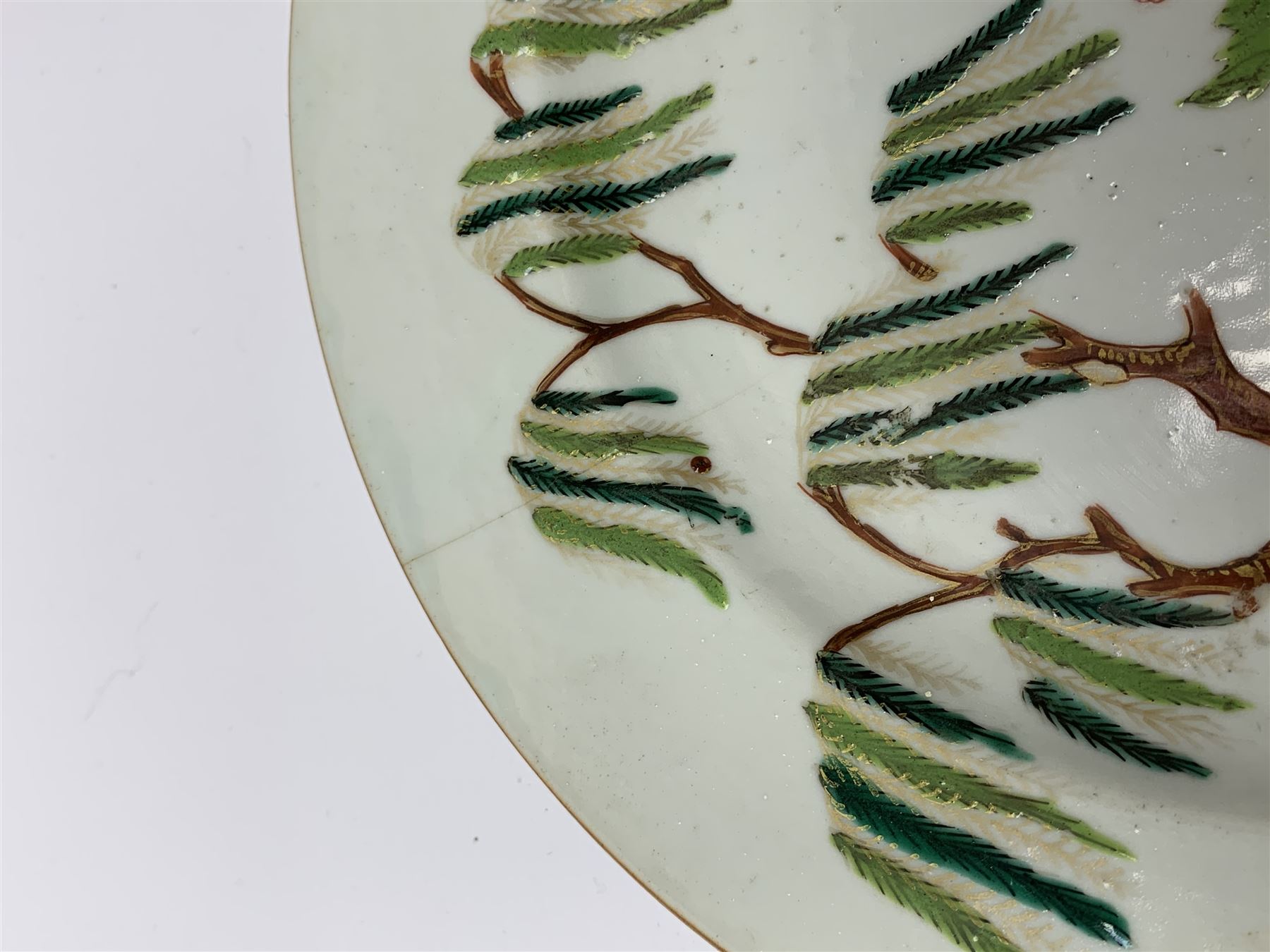 Three 18th Chinese plates, decorated in the Famille Rose pallet with various motifs including peonies, prunus blossom, willow, rockwork and fence, each approximately D13cm