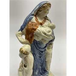 Late 18th century Prattware figure representing Charity, modelled as a mother with baby in her arms and two small children clutching at her robes, upon a square base, overall H21cm.