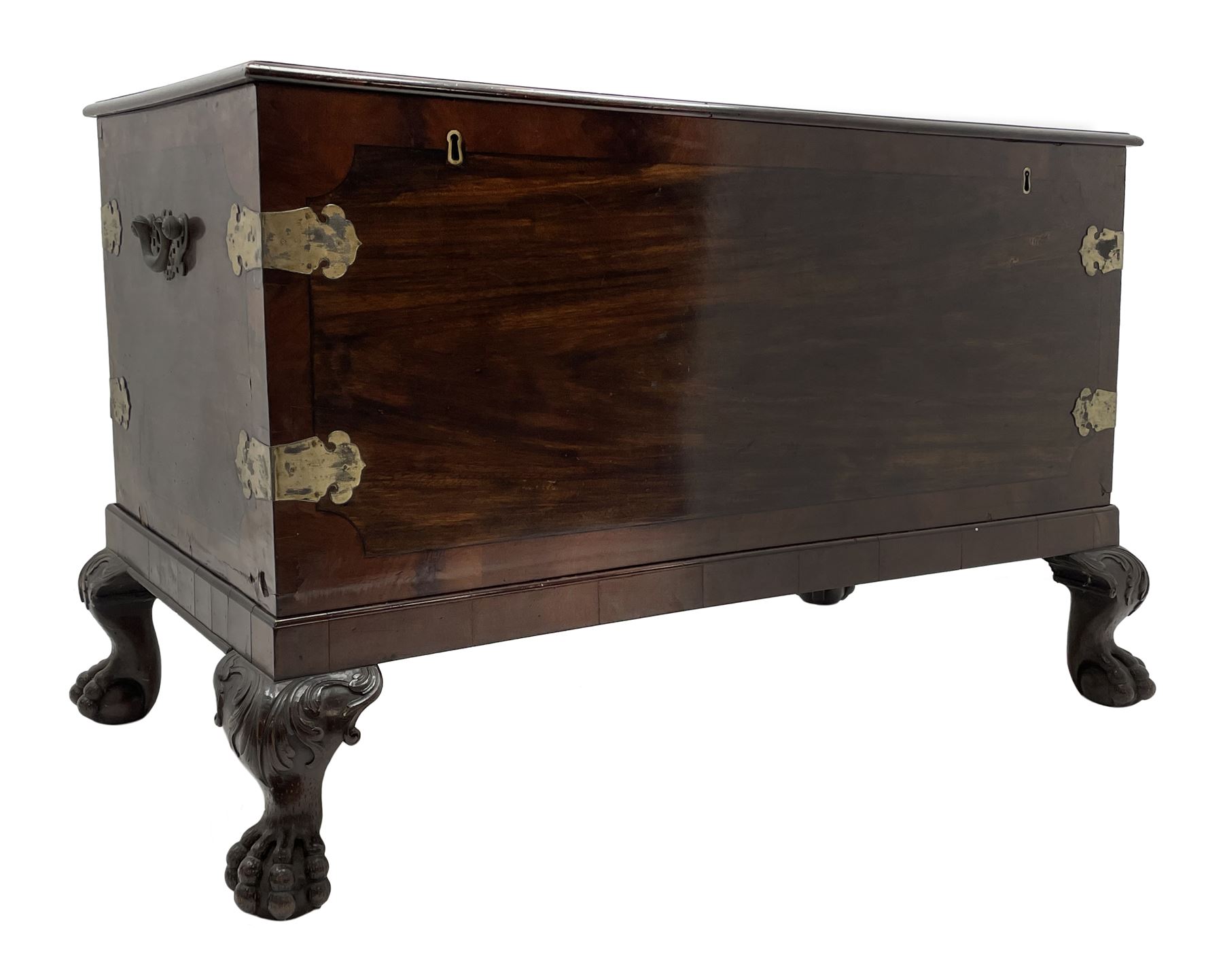 19th century camphor wood and mahogany silver chest, the hinged banded top with circular brass mounts which secure the interior strap hinges, fretwork metal strapping to the corners, on stand with plain frieze and acanthus carved cabriole ball and claw feet