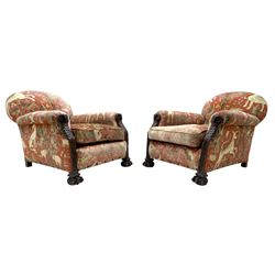 Pair 20th century Country House armchairs, hardwood framed and fully sprung, deep seat with seat cushion upholstered in red ground fabric decorated with trees and wildlife, the arm terminals and supports carved with owl mask and trailing harebells, carved ball and claw feet