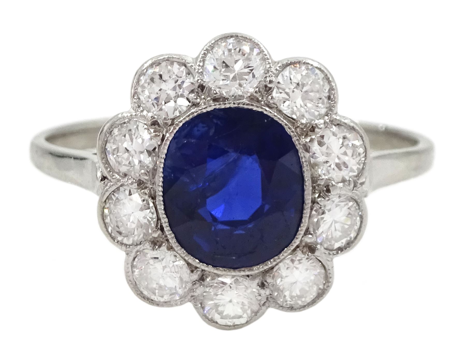 Palladium and platinum milgrain set oval sapphire and diamond cluster ring, sapphire approx 1.35 carat, total diamond weight approx 0.55 carat