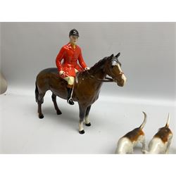 Beswick hunting group, comprising huntswoman on grey horse no 1730, huntsman on brown horse no 1501, two seated fox figures no 1748 and seven fox hounds, all with printed marks beneath (11)