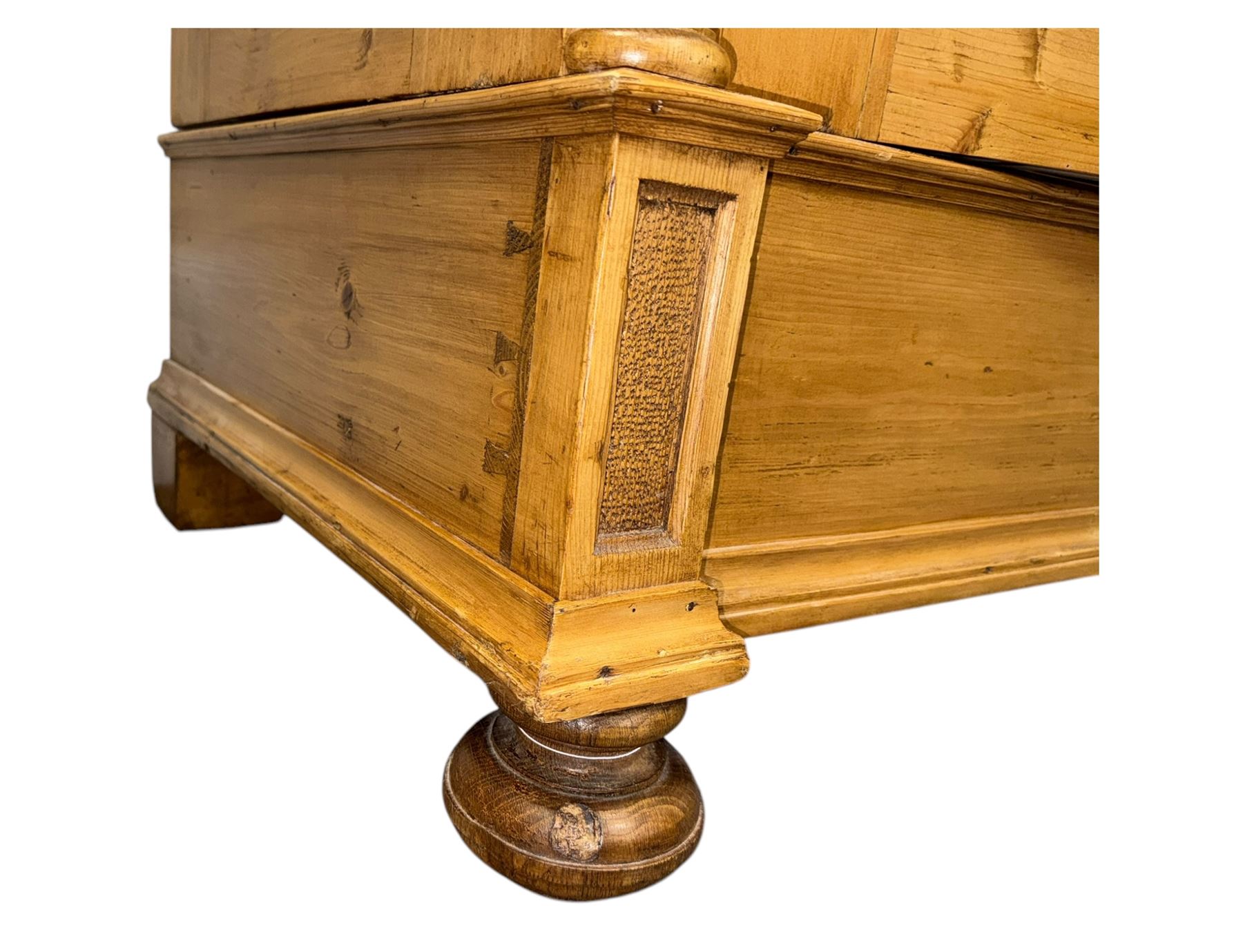 Large 19th-century Continental polished pine double wardrobe, panelled back and doors revealing brass hanging rod, flanked by half-turned columns with Corinthian capitals supported on bun feet
