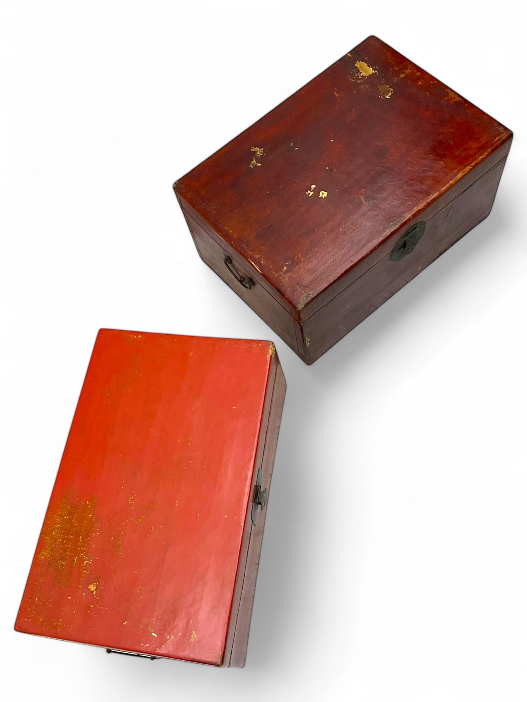 Pair of Chinese 18th century hand-painted leather-bound wooden trunks, each adorned with metal locks, twin carrying handles and patterned fabric-lined interior