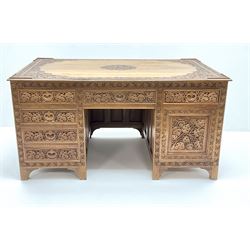 Large eastern hardwood desk, heavily carved with floral detailing shaped supports