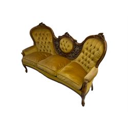 Victorian style stained beech double ended settee, the cresting rail carved with leaf motifs, pierced and carved back decorated with scrolling foliage ans fruit, in buttoned upholstery, moulded cabriole supports