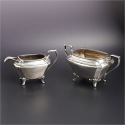 Silver two handled sugar bowl and matching milk jug raised on shaped supports Sheffield 19...