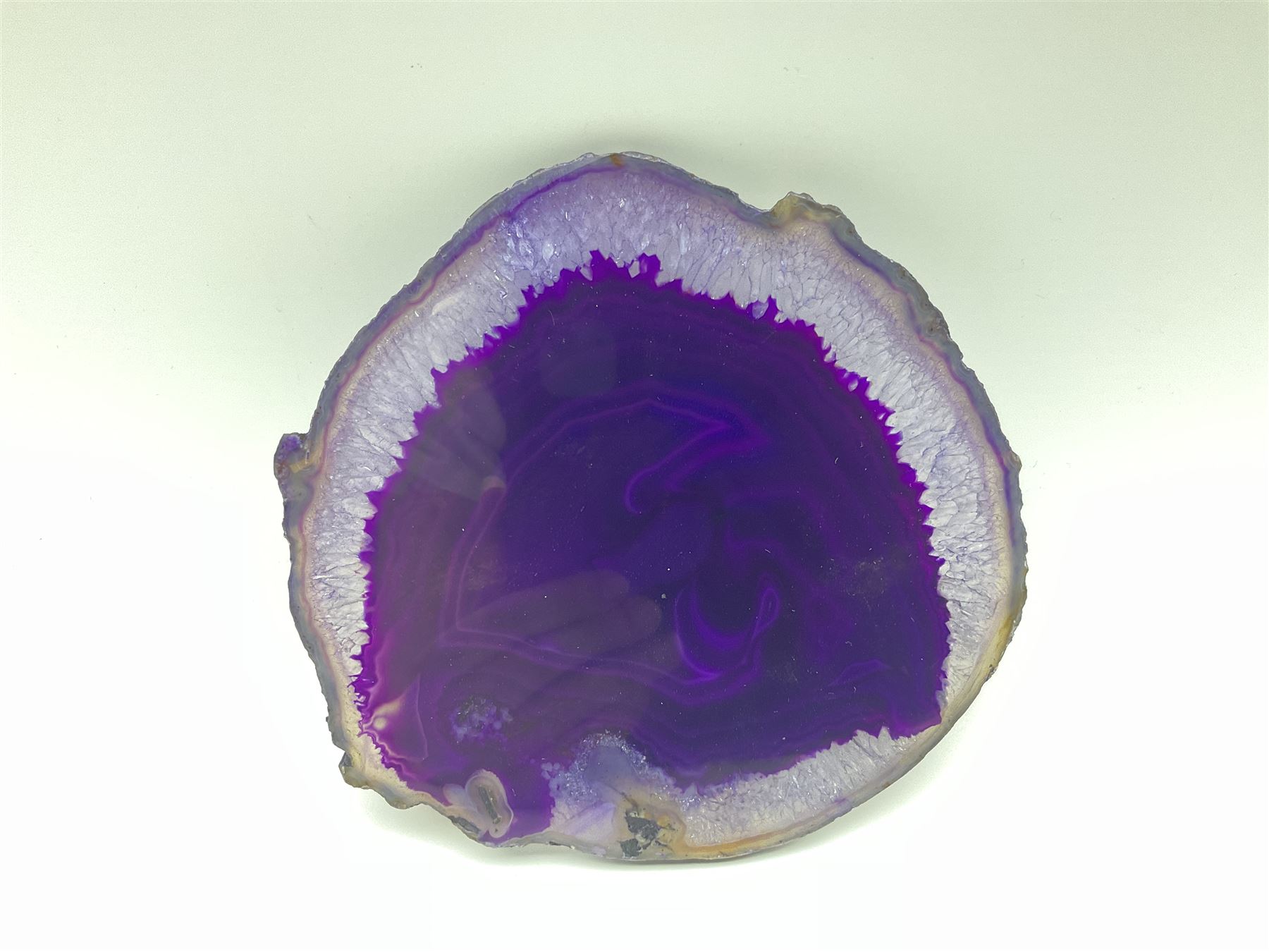 Pair of purple agate slices, polished with rough edges, raised upon gilt metal stands