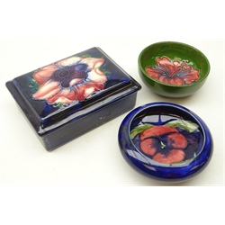  Moorcroft 'Anemone' pattern trinket box and cover, labelled 'Potter To The Late Queen Mary' and two Moorcroft pin dishes, one in the 'Pansy' pattern & the other 'Hibiscus' (3)  