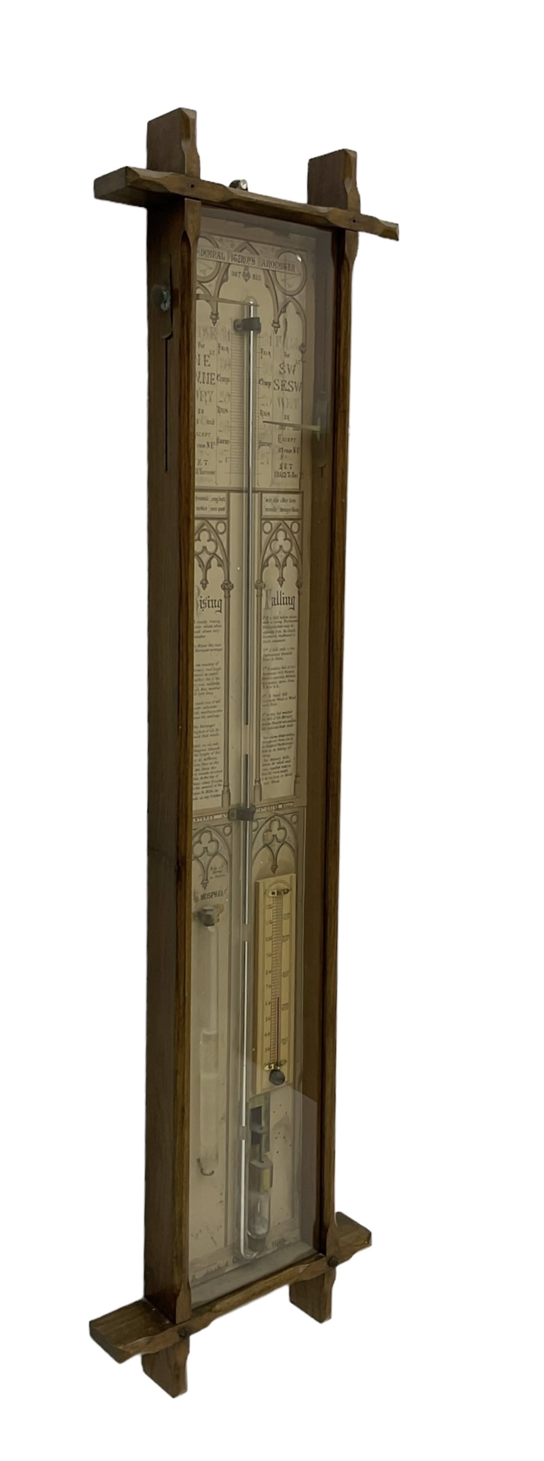 Admiral Fitzroy - Early 20th century Fitzroy barometer in a glazed gothic influenced oak case with chamfered uprights and top and base panels, full length paper scales with Fitzroy's observations and predictions, mercury bulb cistern, storm glass, spirit thermometer and brass sliding vernier pointers. Retailed by Inglis & Son, Coney Street, York.