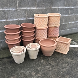  Twenty nine pots comprising of eleven terracotta cylindrical pots with lattice design (maximum D35cm) eight terracotta stackable flower pots (D34cm, H31cm) and a quantity of other pots   
