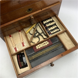  Dentistry - Late Victorian mahogany Dentists cabinet by C. Ash & Co, hinged cover above six long graduated drawers, enclosing a comprehensive arrangement of implements, pharmaceutical bottles, tools, modelling wax, porcelain teeth, 