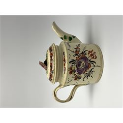 18th century creamware teapot, probably Leeds, with reeded entwined handle and floral finial to the cover, the body with hand painted polychrome decoration of figure to one side, and floral spray to the other, collectors paper label beneath inscribed Leeds Pottery, H11.5cm