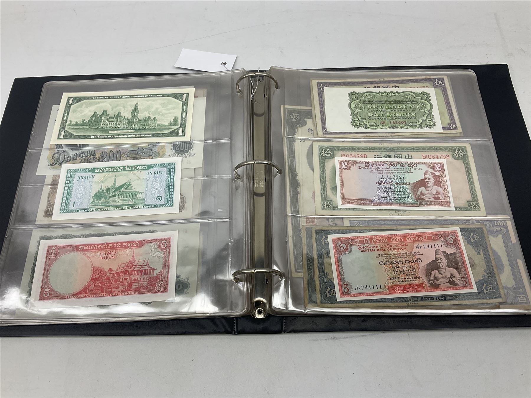 World banknotes, including Queen Elizabeth II The States of Jersey one pound 'DB202703', five pounds 'BB527762' and ten pounds 'AB651481', reserve bank of New Zealand two dollars '1L3 741894', King George V Straits Settlements one dollar 1st January 1935 'F/83 28924', various Bank of England notes etc, housed in two ring binder albums