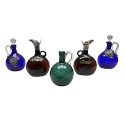 Pair of Victorian brown glass spirit decanters, each with ring handle and silver plated lid and scallop shell thumb piece, (one lacking stopper) H22cm, together with three 19th century decanters with twisted handles, comprising two blue examples and one green, together with four sprit labels