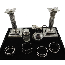 Pair of Edwardian silver dwarf candlesticks, Corinthian design by Boots Pure Drug Company Birmingham 1906, silver cream jug by Jones & Crompton, Birmingham 1901, silver cut glass scent bottle and four silver napkin rings, hallmarked  