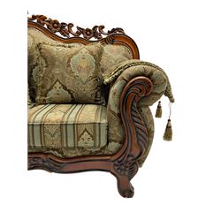 Italian Baroque design three seat sofa, hardwood framed, the cresting rail carved and pierced with c-scrolls and flower heads, scrolled arms, upholstered in floral patterned and striped fabric, with scatter cushions 