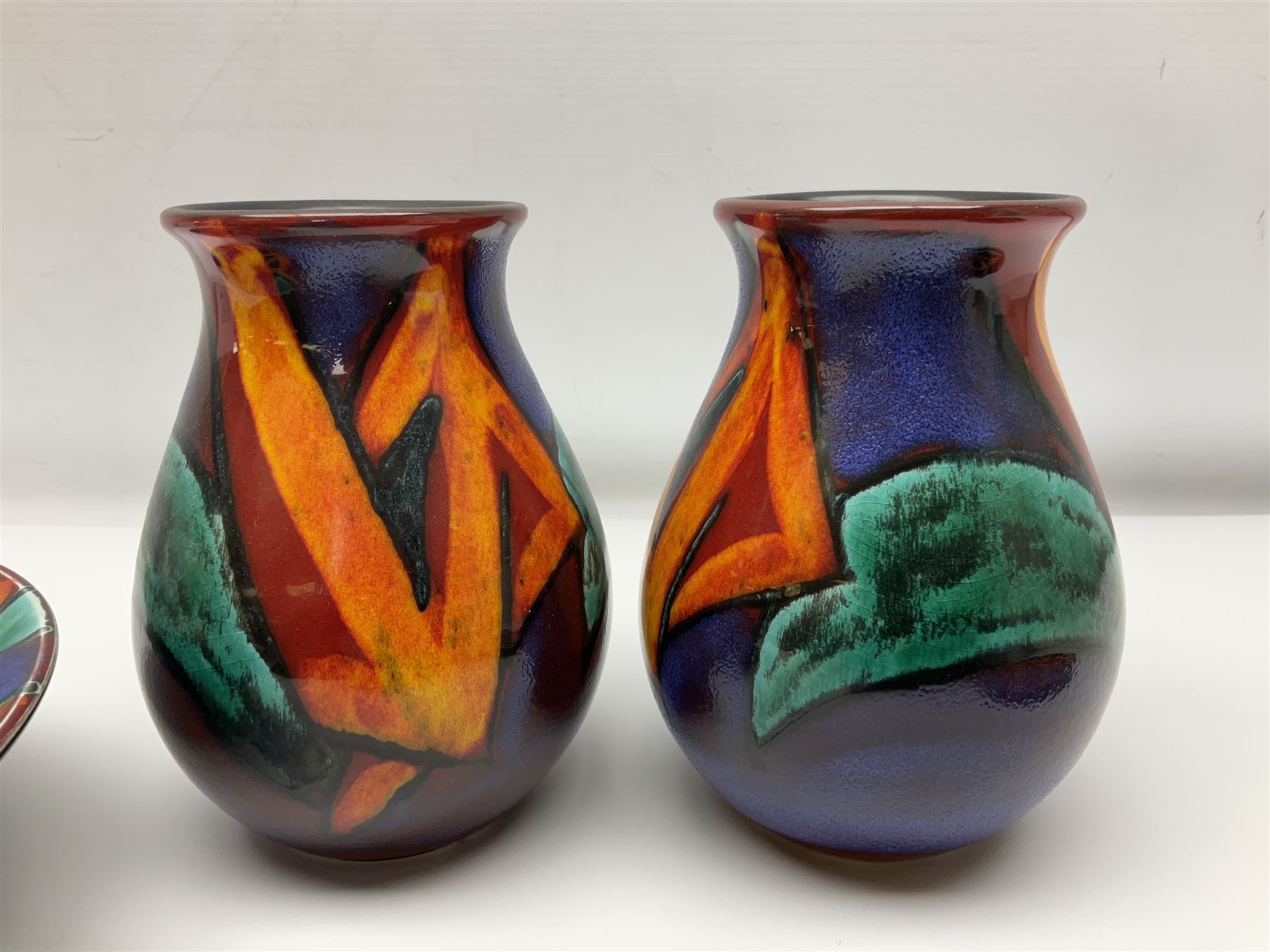 Four pieces of Poole Pottery in Graffiti pattern, comprising pair of vases of baluster form, dish and small plate, with impressed or printed marks beneath, vase H17cm
