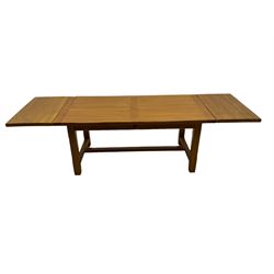 Light oak rectangular dining table with two additional leaves, square supports joined by floor stretcher