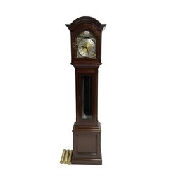 Mahogany cased Grandmother clock c 1980 made and retailed by Julian Stanton, Winchester, with a break arch pediment and corresponding brass dial, full length glazed door displaying three brass cased weights and pendulum, raised on a square plinth with a recessed panel and skirting, German Kieninger three train chain driven movement striking the hours and quarters on 12 gong rods. With weights and pendulum.  