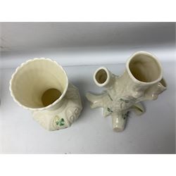 Five late 19th/early 20th century and later Belleek vases, comprising pair of Lotus Blossom examples, shamrock tree trunk vase, twin handled shamrock vase and a baluster form vase decorated with applied roses, all with printed marks beneath, tallest H16cm