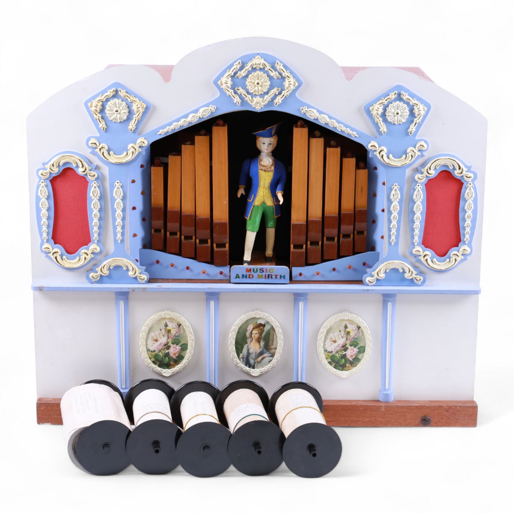 John Smith-20th century hand cranked portable street organ “music and mirth” in a wooden case with carrying handles, with speaking pipes and mannequin to the front. All pipes present, however the mechanism is in need of restoration. With five paper music rolls.