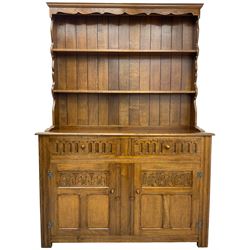 Mid-20th century oak dresser, raised two heights plate rack over two drawers and two cupboards