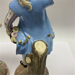 Pair of late 19th/early 20th Century Meissen figures, modelled as flower sellers, after the original by Michel Victor Acier, she holding basket of flowers, he holding flowers in his hat, each with underglaze cross swords mark beneath, tallest H16.5cm