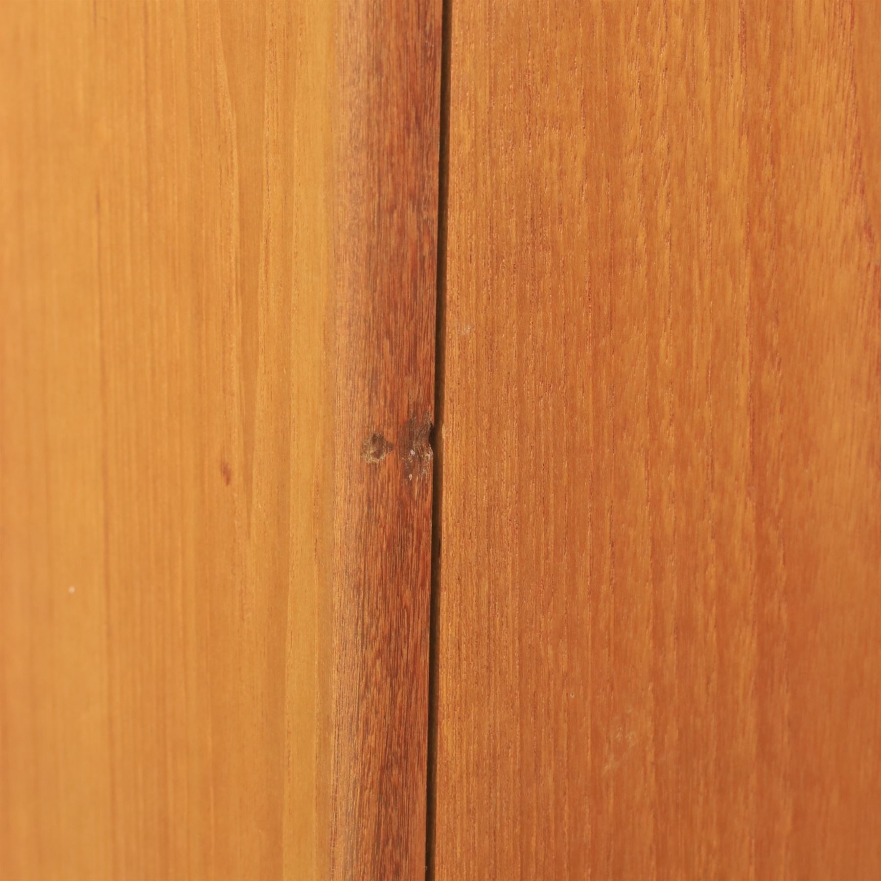 G Plan - 'Fresco' teak double wardrobe, twin doors enclosing a single clothes rail, on a recessed plinth base with castors beneath  