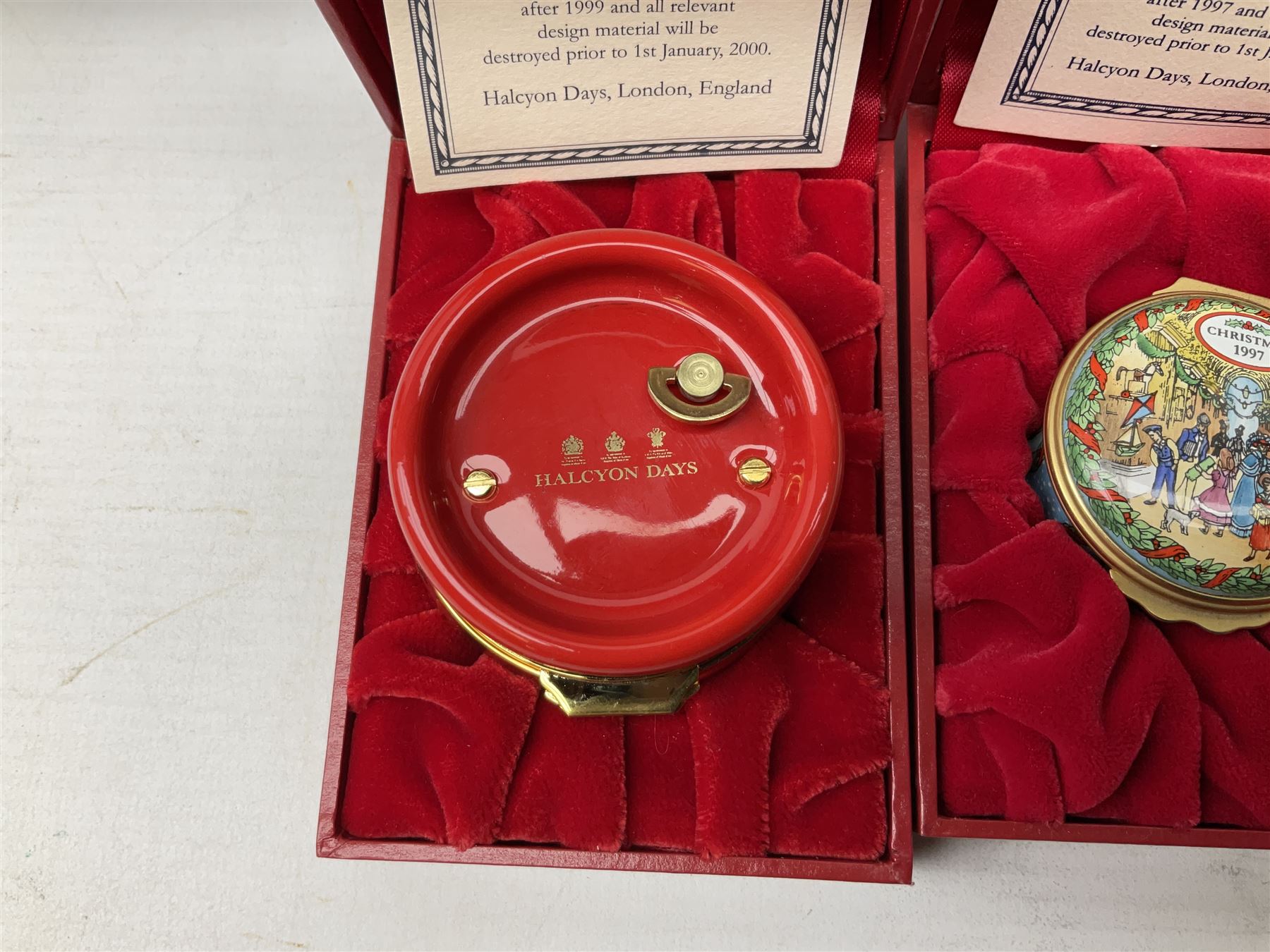 Eight Christmas themed Halcyon Days enamel boxes, and a Halcyon Days enamel bonbonniere modelled as a snowman, each in fitted box 