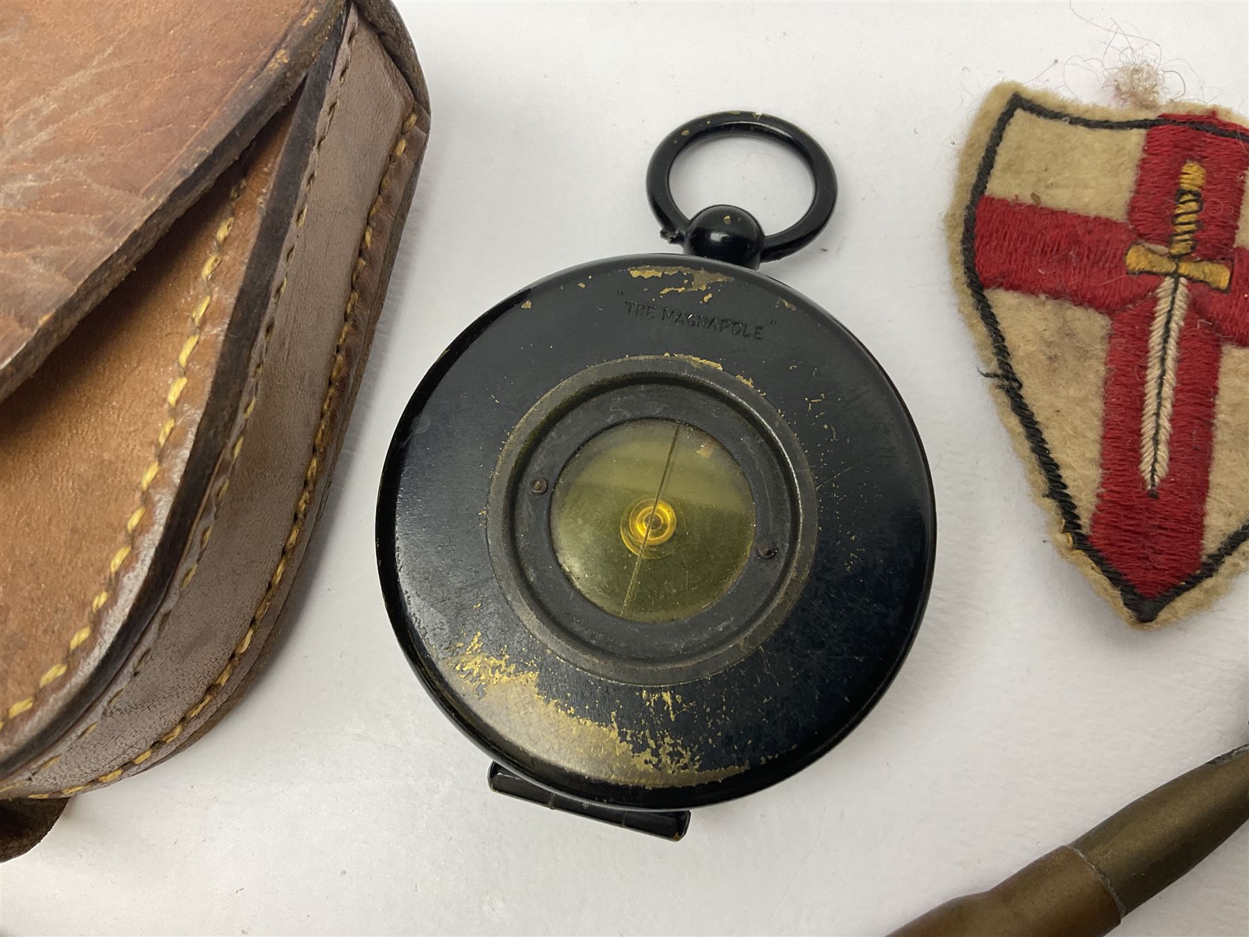 WW1 Short & Mason Ltd 'The Magnapole' black japanned brass field compass in leather carrying case; WW1 trench art paper knife inscribed Dixmude; and small quantity of cloth badges etc