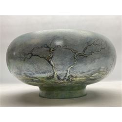 Wooden hand painted bowl, decorated with trees on a blue ground, signed Phil Crennell beneath, D28cm