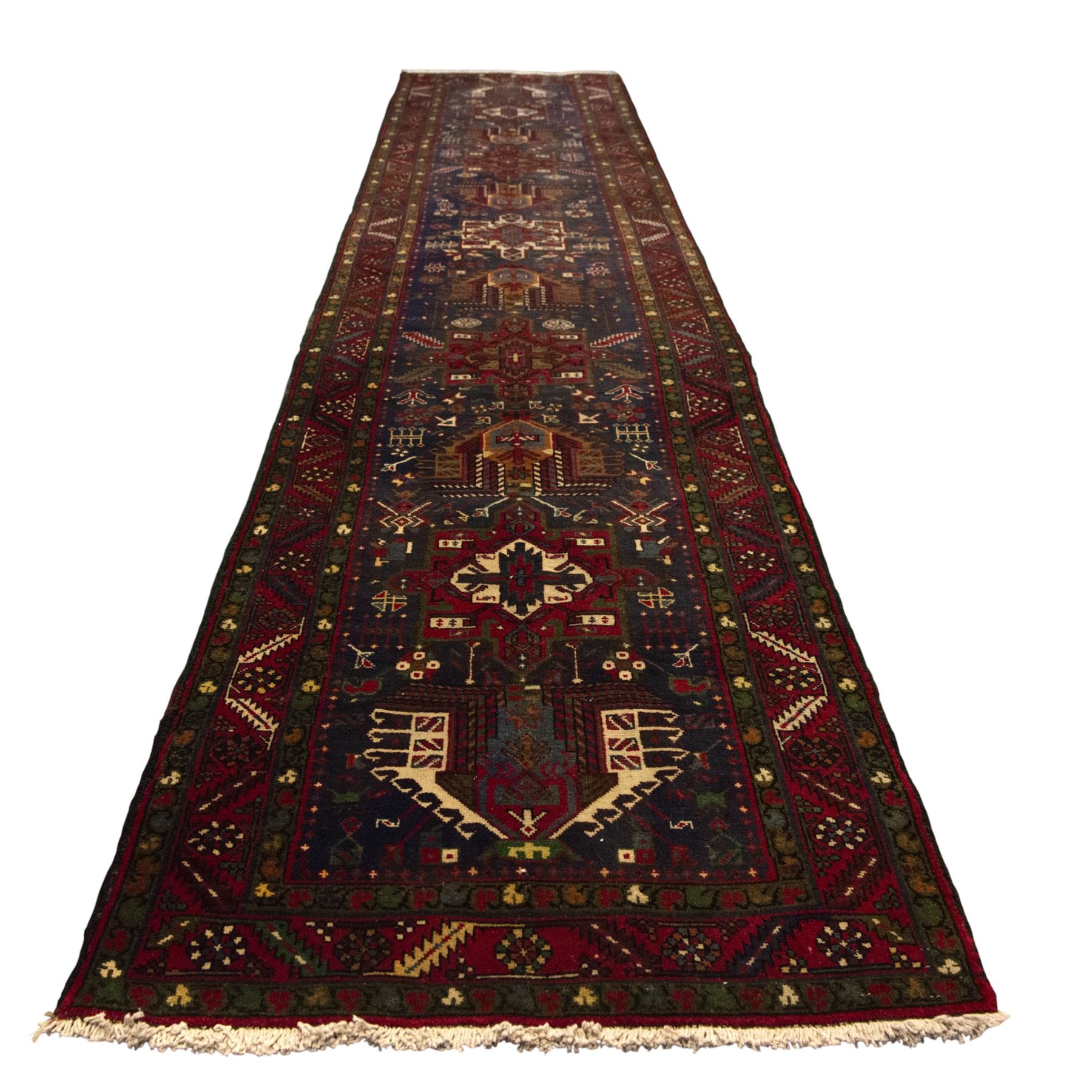 Large Northwestern Persian Hamadan hand-knotted runner, indigo field, with a column of bold geometric medallions and scattered stylized motifs within a madder border of angular rosettes and meandering vines 