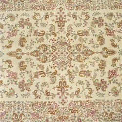Persian Isfahan cream ground rug, overall floral design, sparse field decoration with trailing flower head and Boteh motifs, repeating floral pattern boarder with repeating motifs 