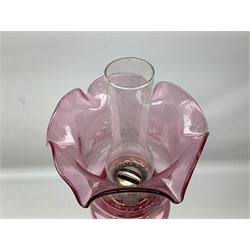 Victorian silver plated oil lamp, the square stepped base leading to a Corinthian column supporting ruby glass reservoir, burner, clear glass chimney and foliate etched ruby glass shade, H81cm