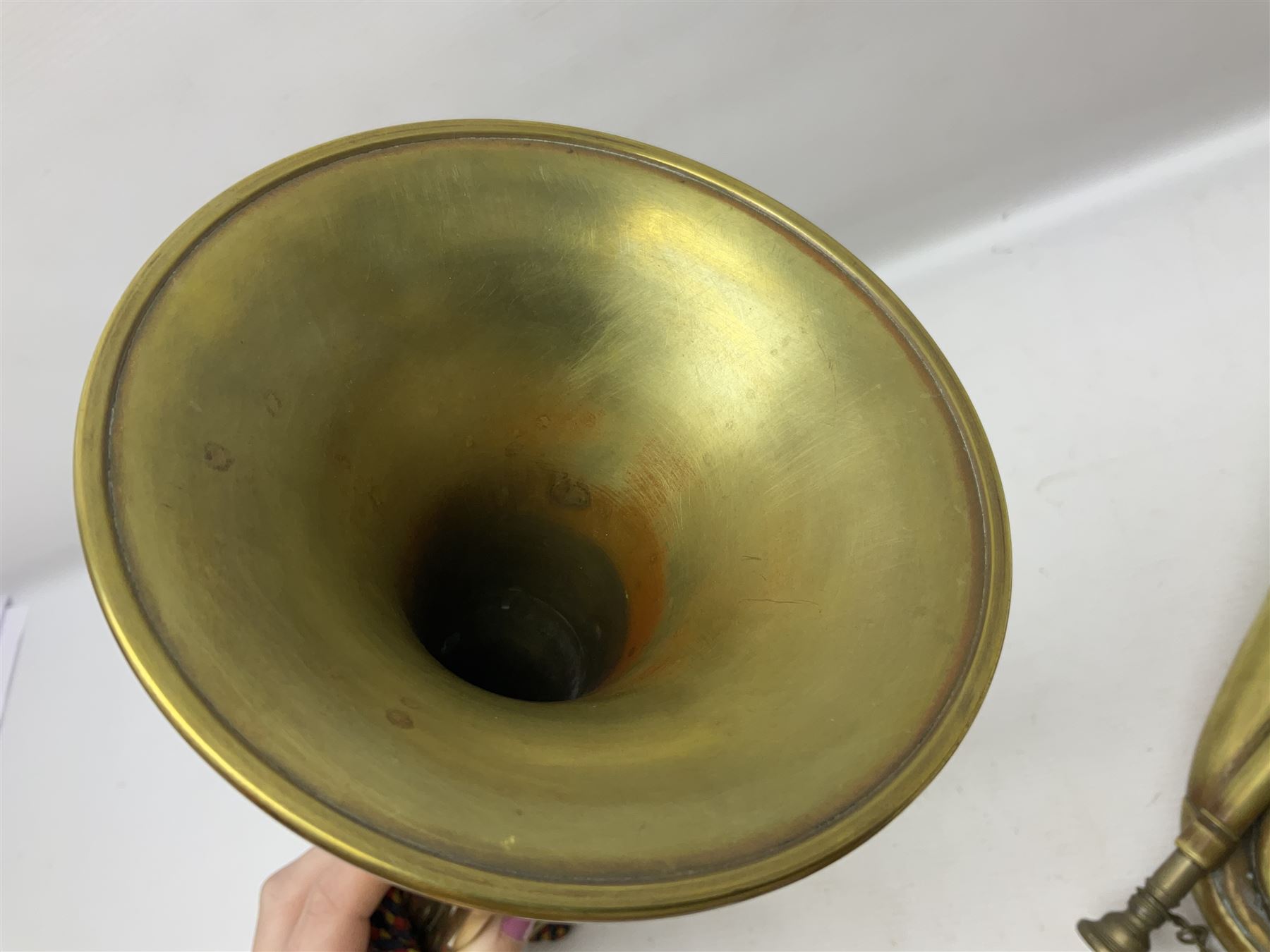 Two military brass bugles by Mayers and Harrison Ltd. Manchester each with crows foot mark and dated 1966; both with multi-coloured cord and tassels, longest 52.5cm (2)