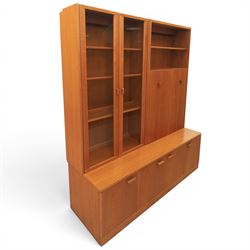 G-Plan - Mid 20th century teak modular wall unit, the upper section fitted with twin glazed doors enclosing shelves, adjoining concertina doors with mirrored and shelved interior, the base with four cupboard doors with recessed rectangular handles, raised on a plinth base