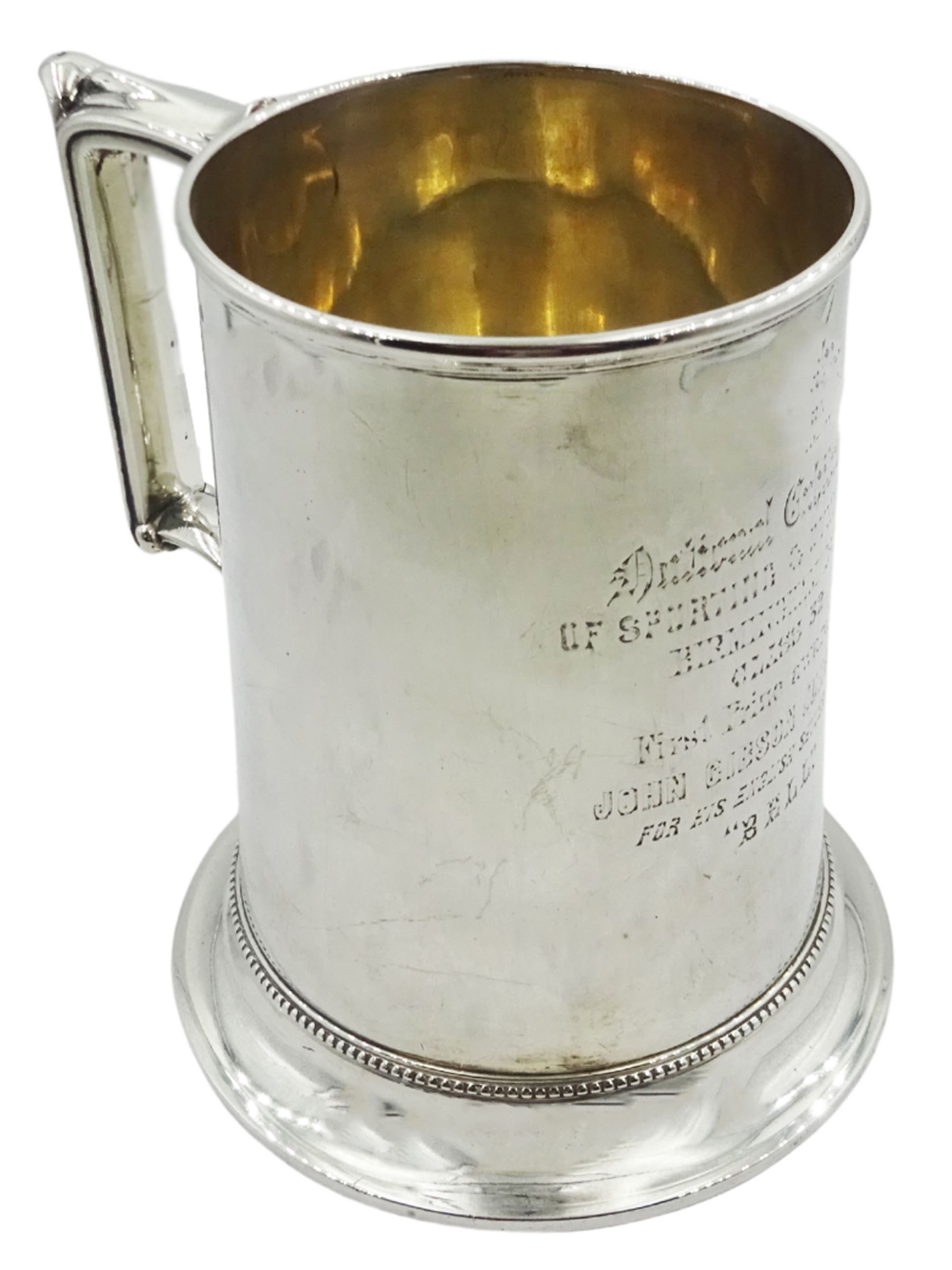 Victorian silver tankard of slightly tapering cylindrical form with engraved dedication to body, and angular scroll handle, upon a flared foot with beaded border, hallmarked Birmingham 1868, H14cm, approximate weight 13.76 ozt (428.2 grams)