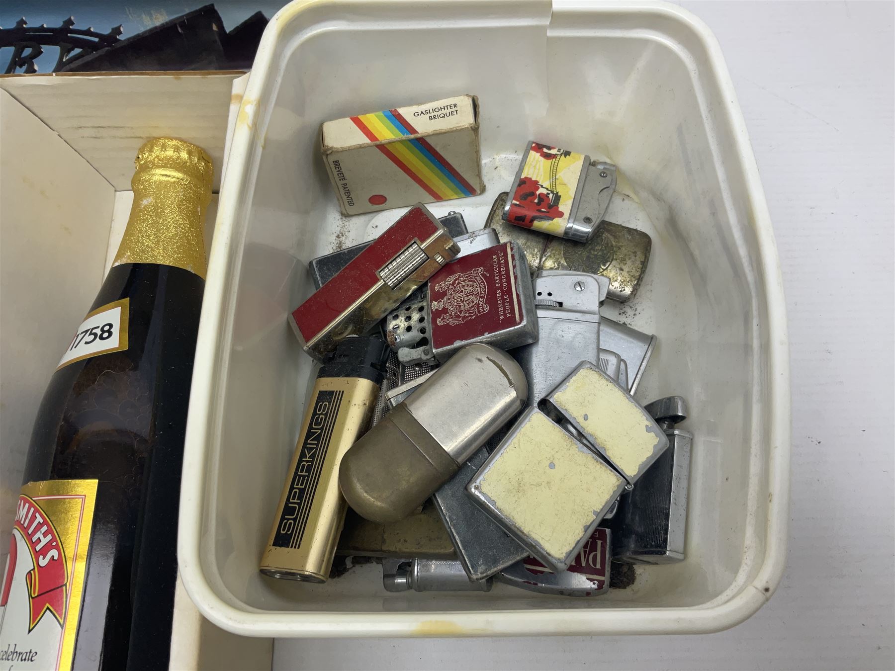 John Smiths presentation box commemorating 100 years of the Tadcaster brewery, containing two bottles of special brew and a glass, and a collection of lighters including Ronson and Jutson